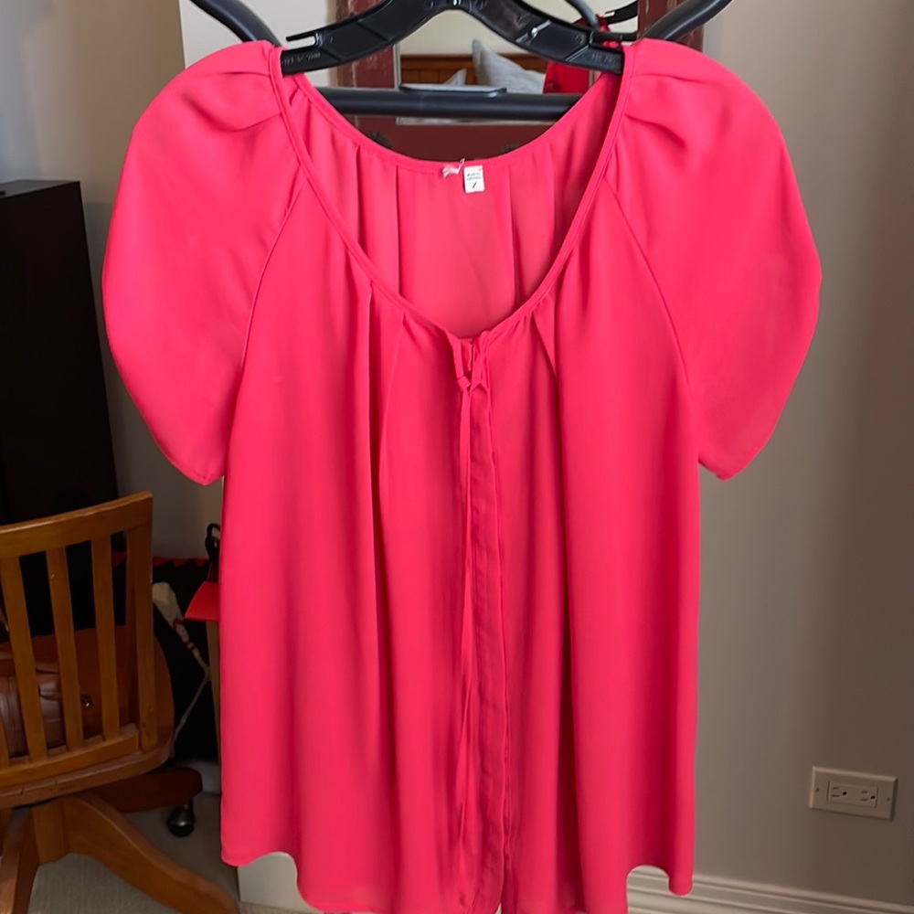 Red blouse with buttons and bow detail
